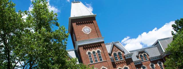 University Hall with Blue Cloudy Skies and Green Trees